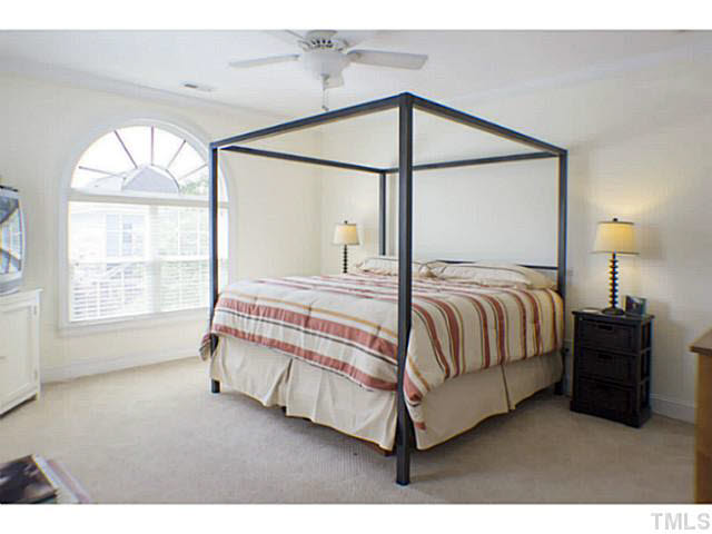 1172 Harp Street Raleigh, NC 27604 - Photo 17 of 25 a bedroom with a bed window and a night stand