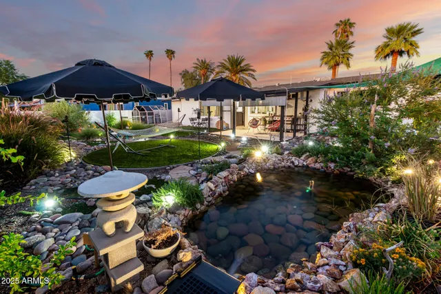 a front view of a house with a yard fire pit and furniture