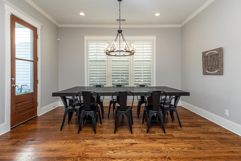 328 Washington Street Collierville, TN 38017 - Photo 12 of 33 Breakfast area featuring rich wood-finish flooring, a contemporary chandelier, recessed lighting, and a window with plantation shutters