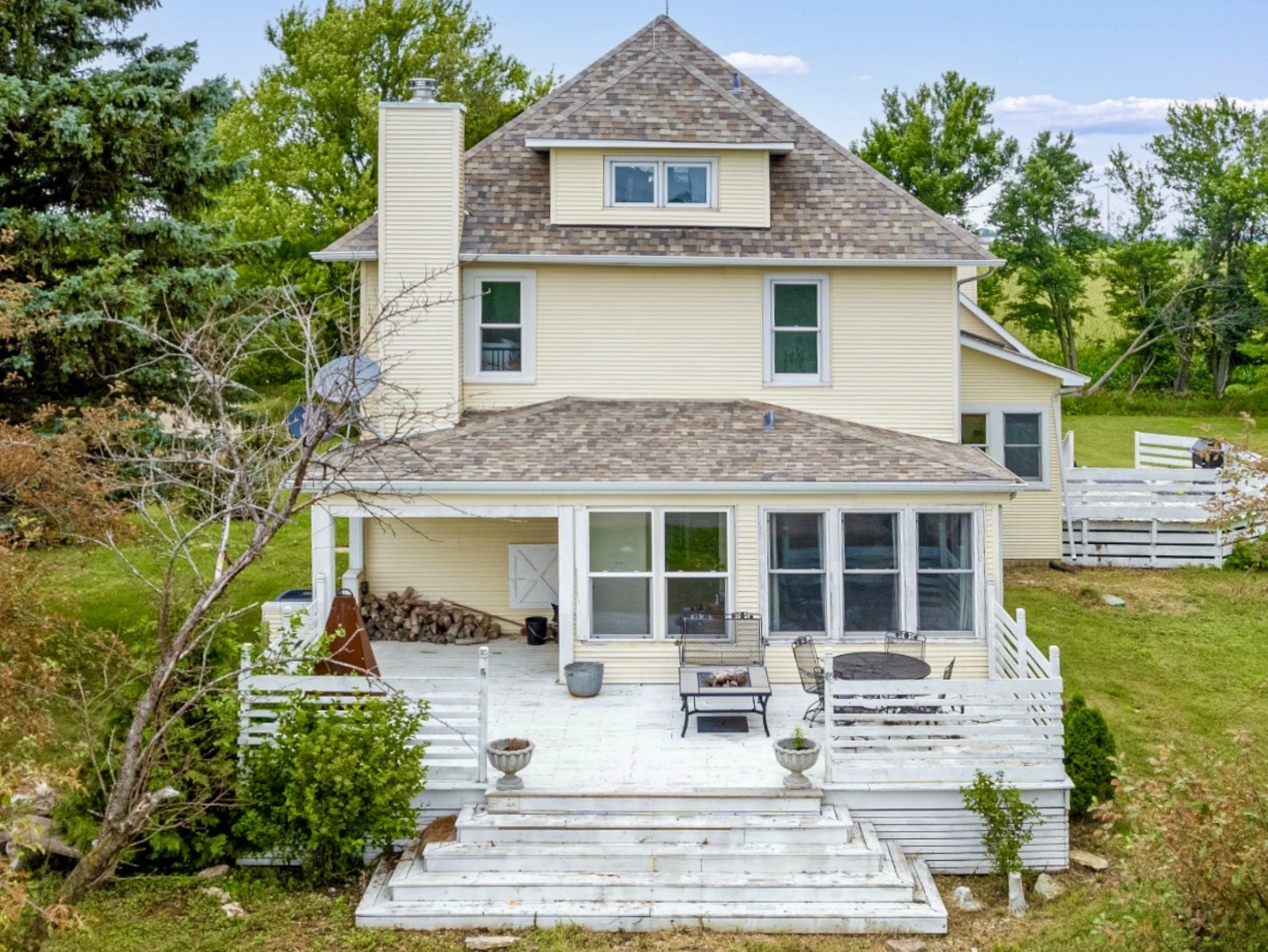 a view of a house with a yard and sitting area