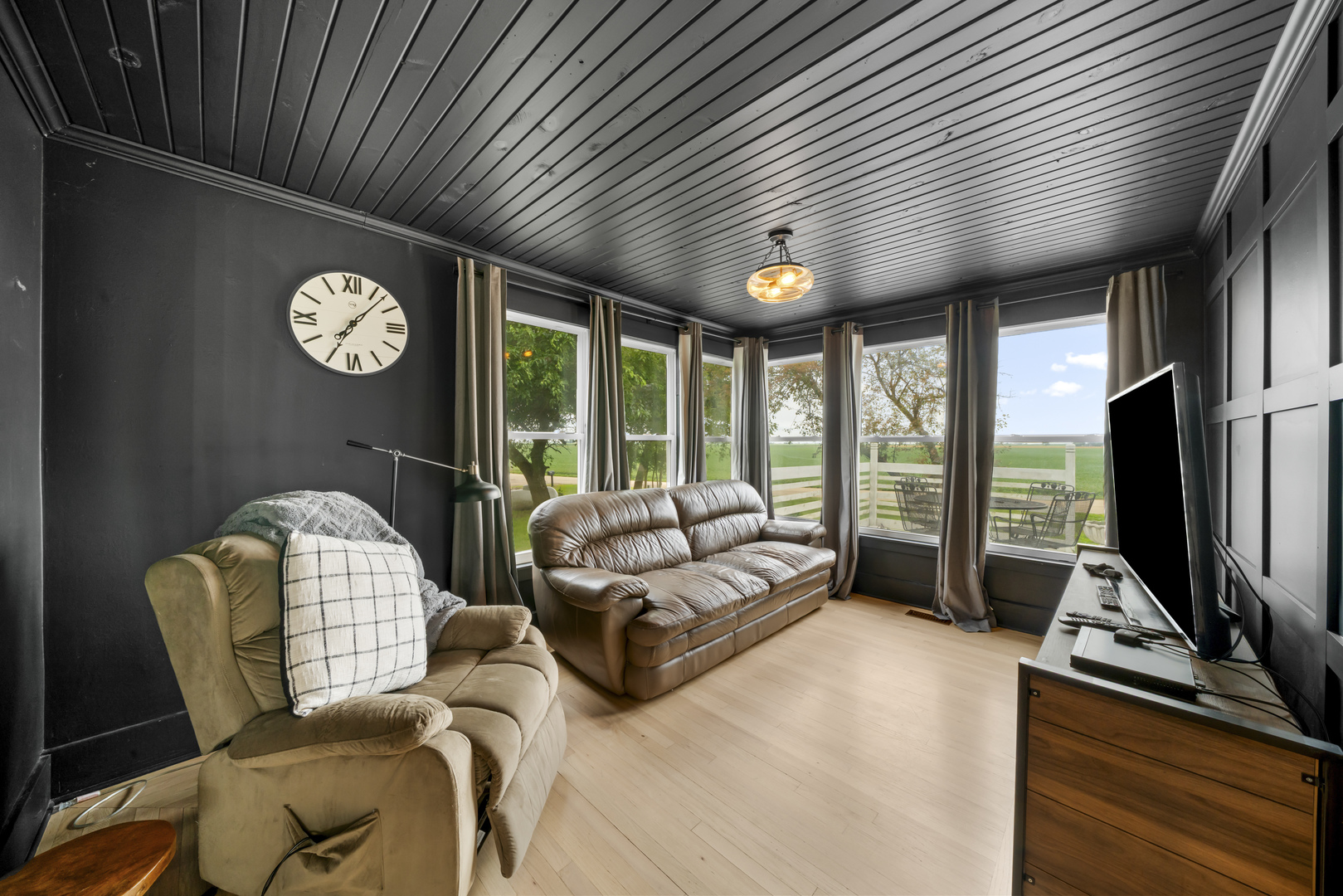 3705 Elva Road Malta, IL 60150 - Photo 18 of 42 a living room with furniture a flat screen tv and a large window