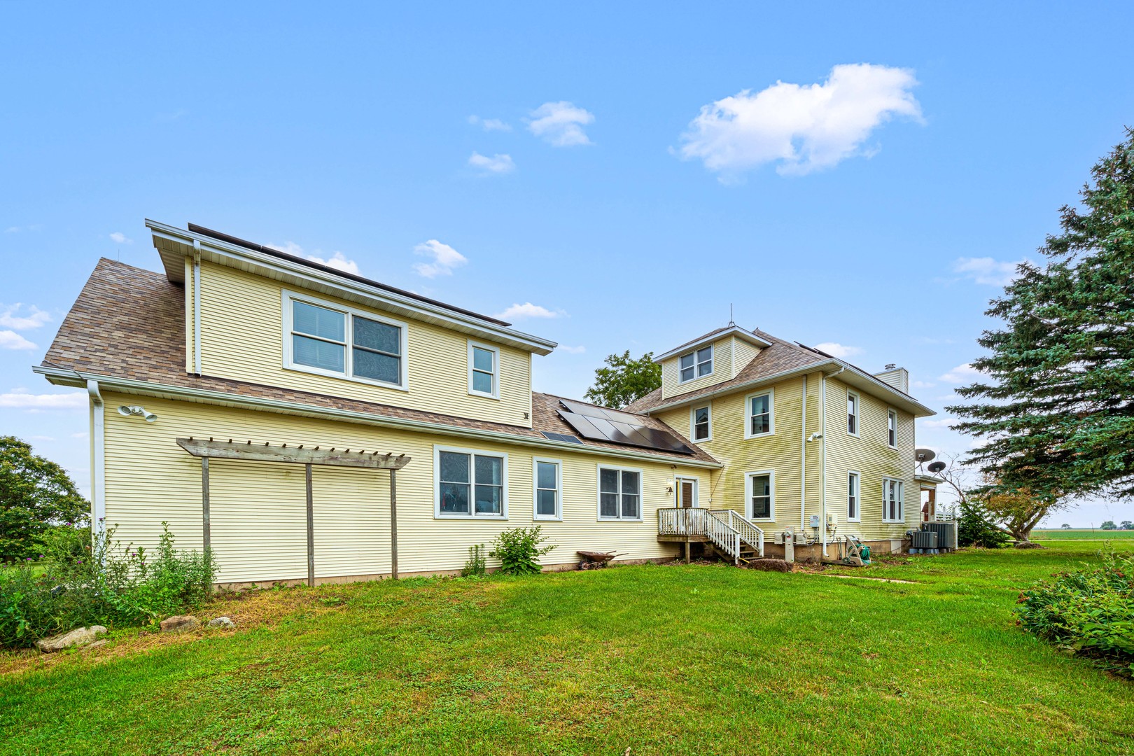 3705 Elva Road Malta, IL 60150 - Photo 7 of 42 a view of a yard with a large tree in front of a house
