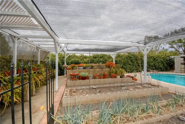 a view of a house with swimming pool and sitting area