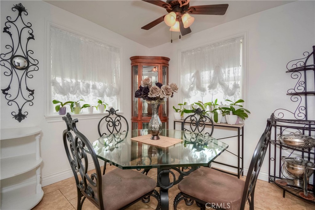 962 West 41st Street San Bernardino, CA 92407 - Photo 6 of 15 a dining room with furniture potted plants and wooden floor