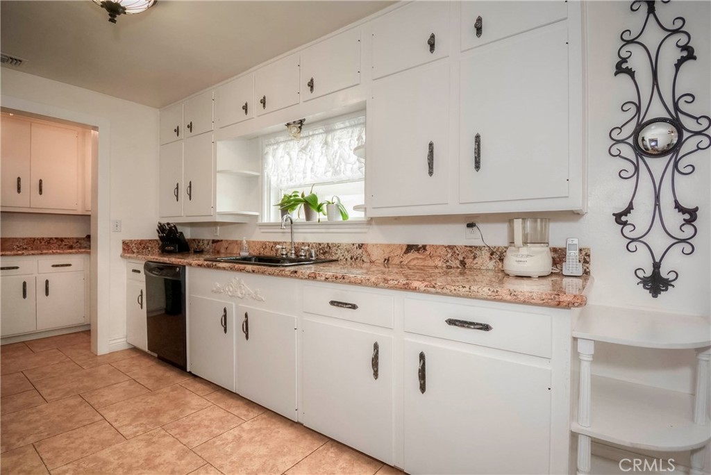 962 West 41st Street San Bernardino, CA 92407 - Photo 7 of 15 a kitchen with granite countertop white cabinets and white appliances