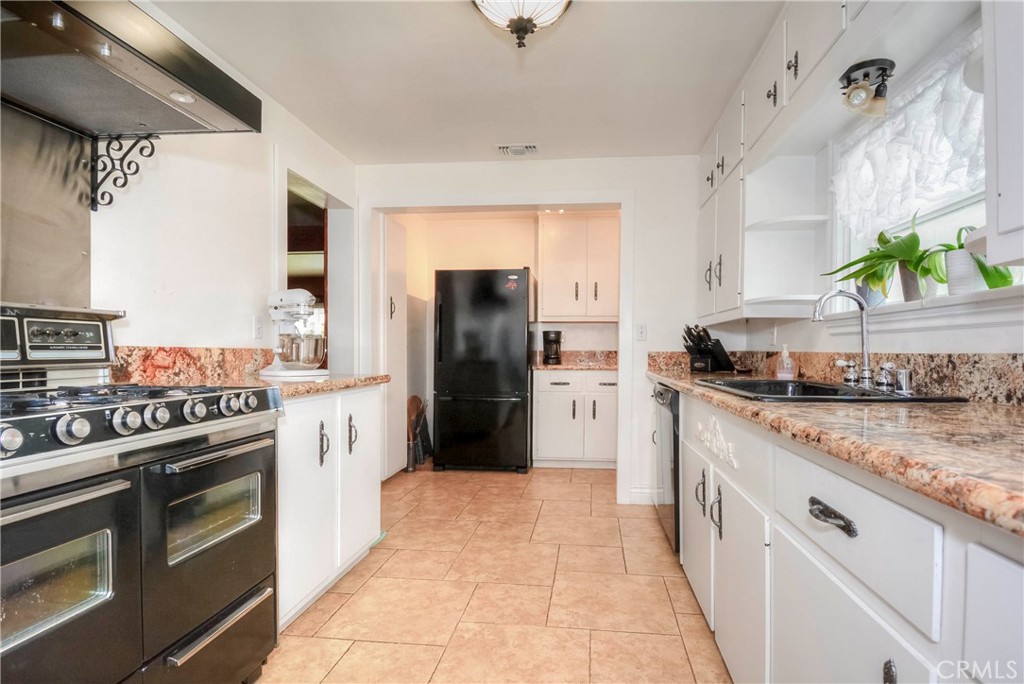962 West 41st Street San Bernardino, CA 92407 - Photo 8 of 15 a kitchen with stainless steel appliances granite countertop a refrigerator a stove and a sink