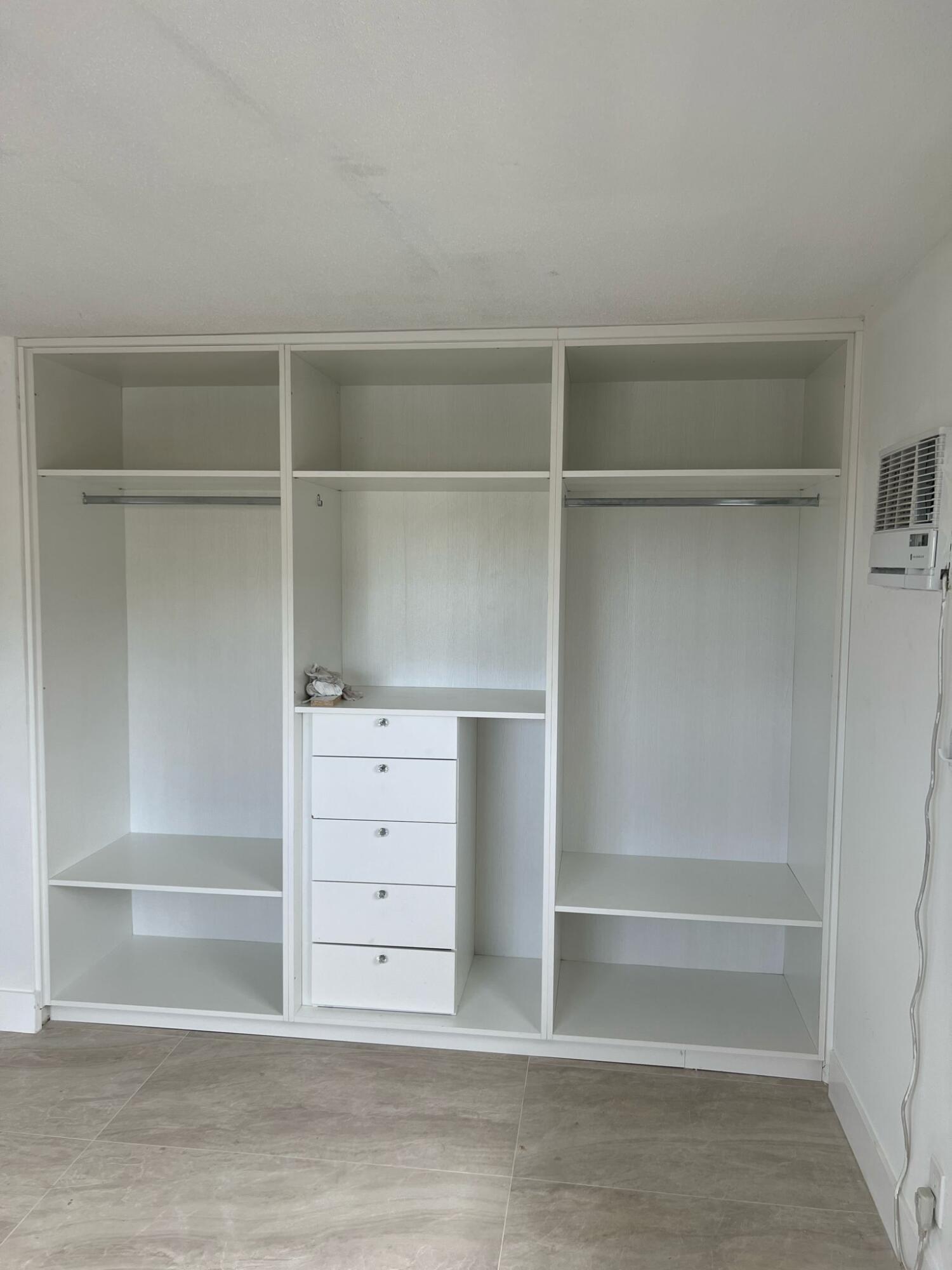 1150 East Sample Road Pompano Beach, FL 33064 - Photo 11 of 12 a view of walk in closet with empty racks