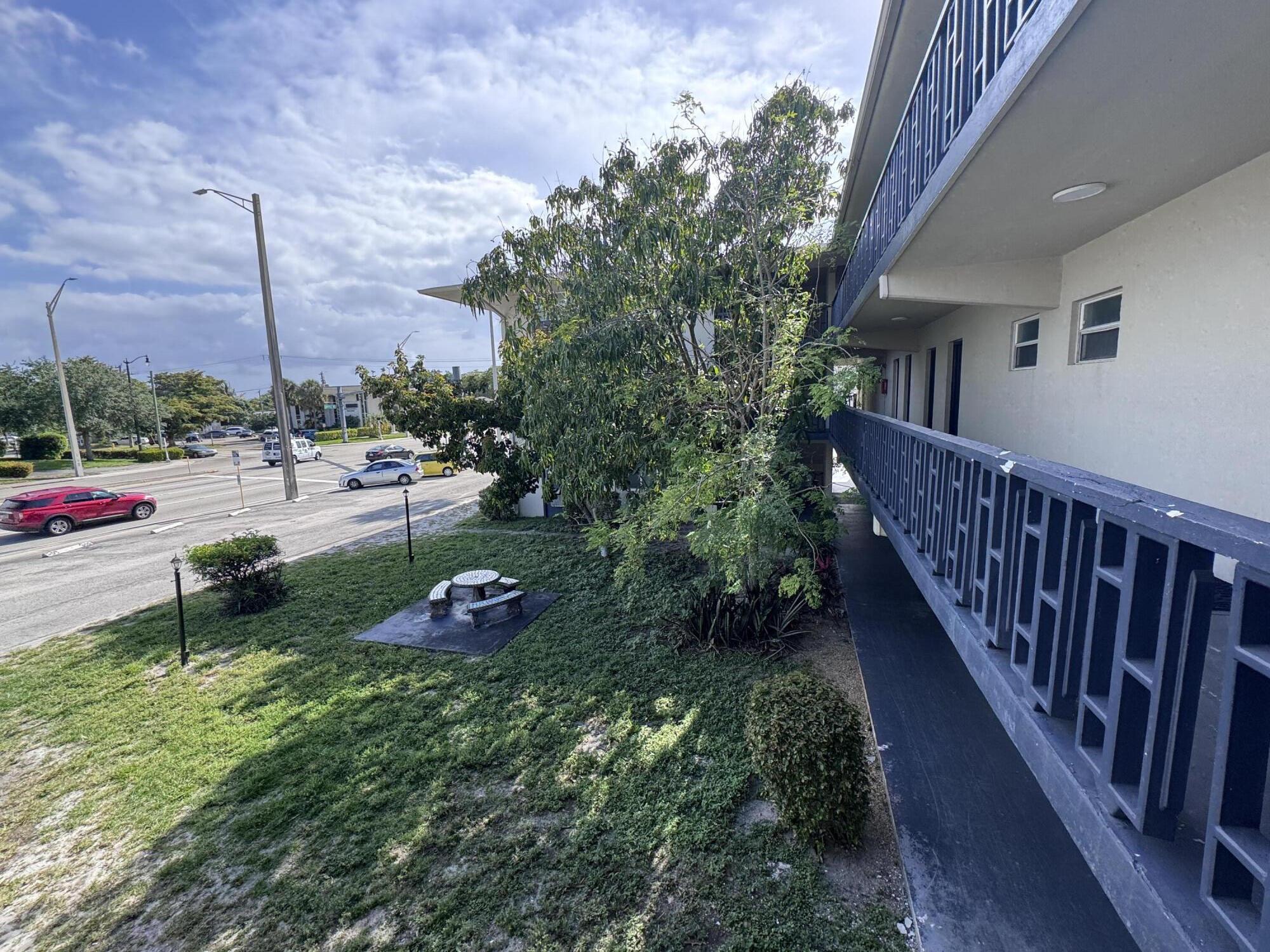 1150 East Sample Road Pompano Beach, FL 33064 - Photo 5 of 12 a garden view with a seating space