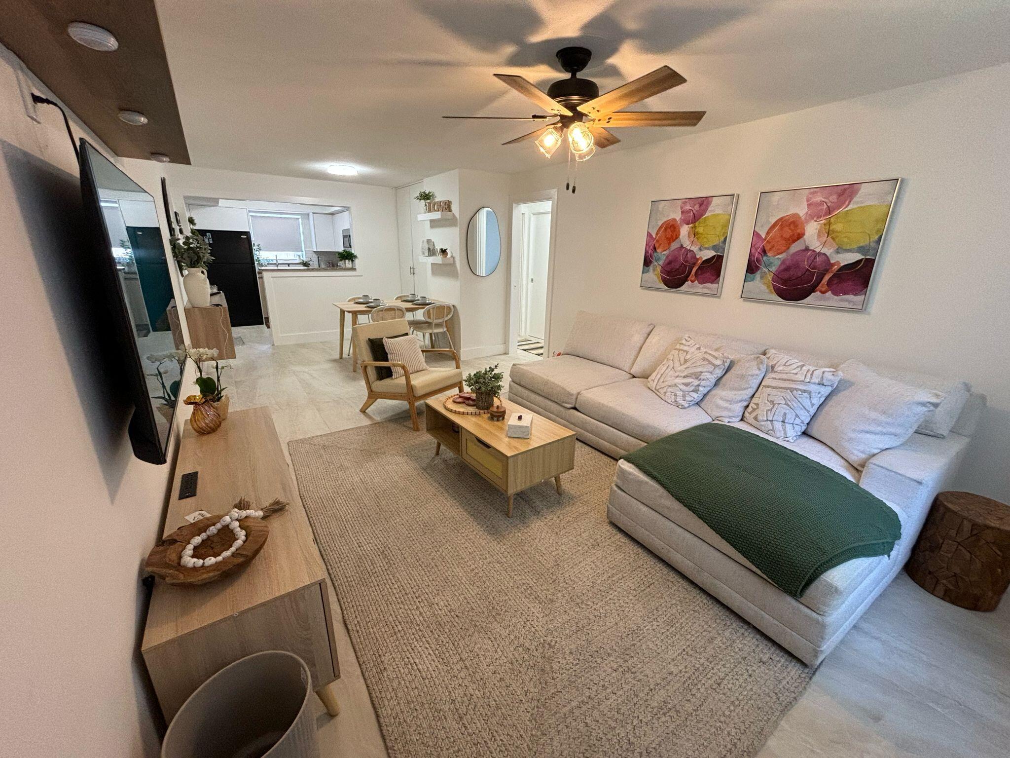 1150 East Sample Road Pompano Beach, FL 33064 - Photo 6 of 12 a living room with furniture and a flat screen tv