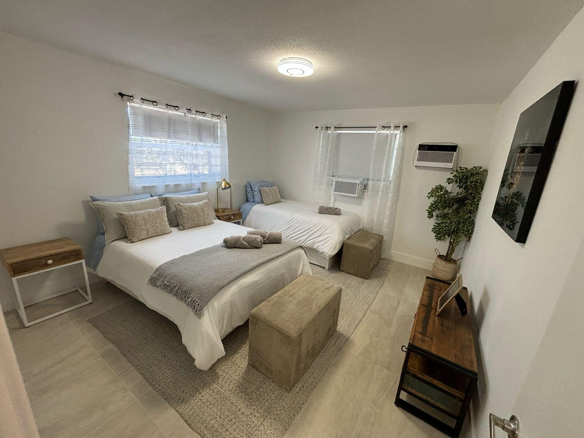 1150 East Sample Road Pompano Beach, FL 33064 - Photo 9 of 12 a bedroom with a bed and a window