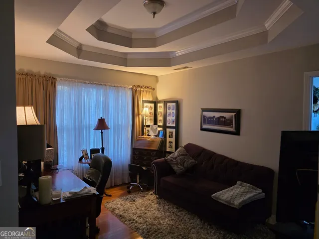 a living room with furniture rug and window