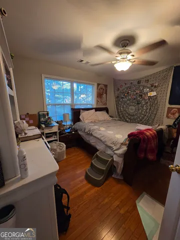 a bed room with furniture and window