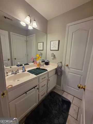 a bathroom with a double vanity sink mirror and