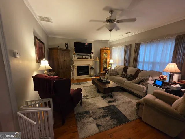 a living room with furniture a fireplace and a flat screen tv