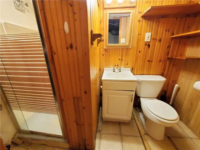 a white toilet sitting next to a bathroom sink