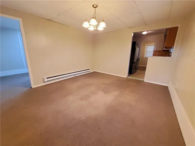 a view of a big room with chandelier and a chandelier fan