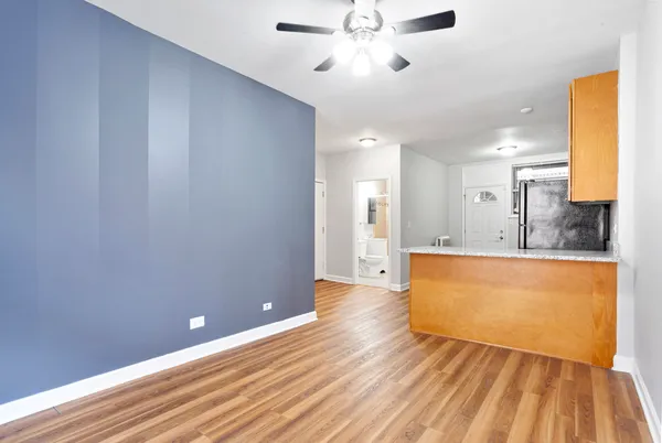 a view of kitchen with sink and wooden floor