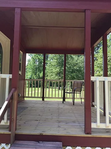 a view of a livingroom with a ceiling fan and window