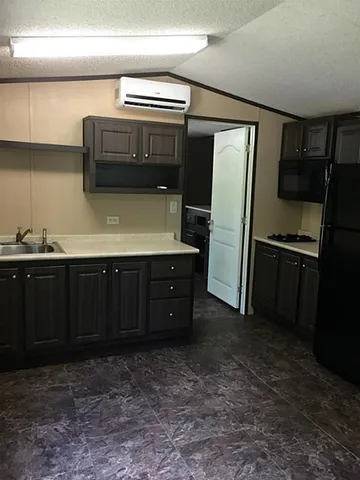 a kitchen with stainless steel appliances a refrigerator and a stove