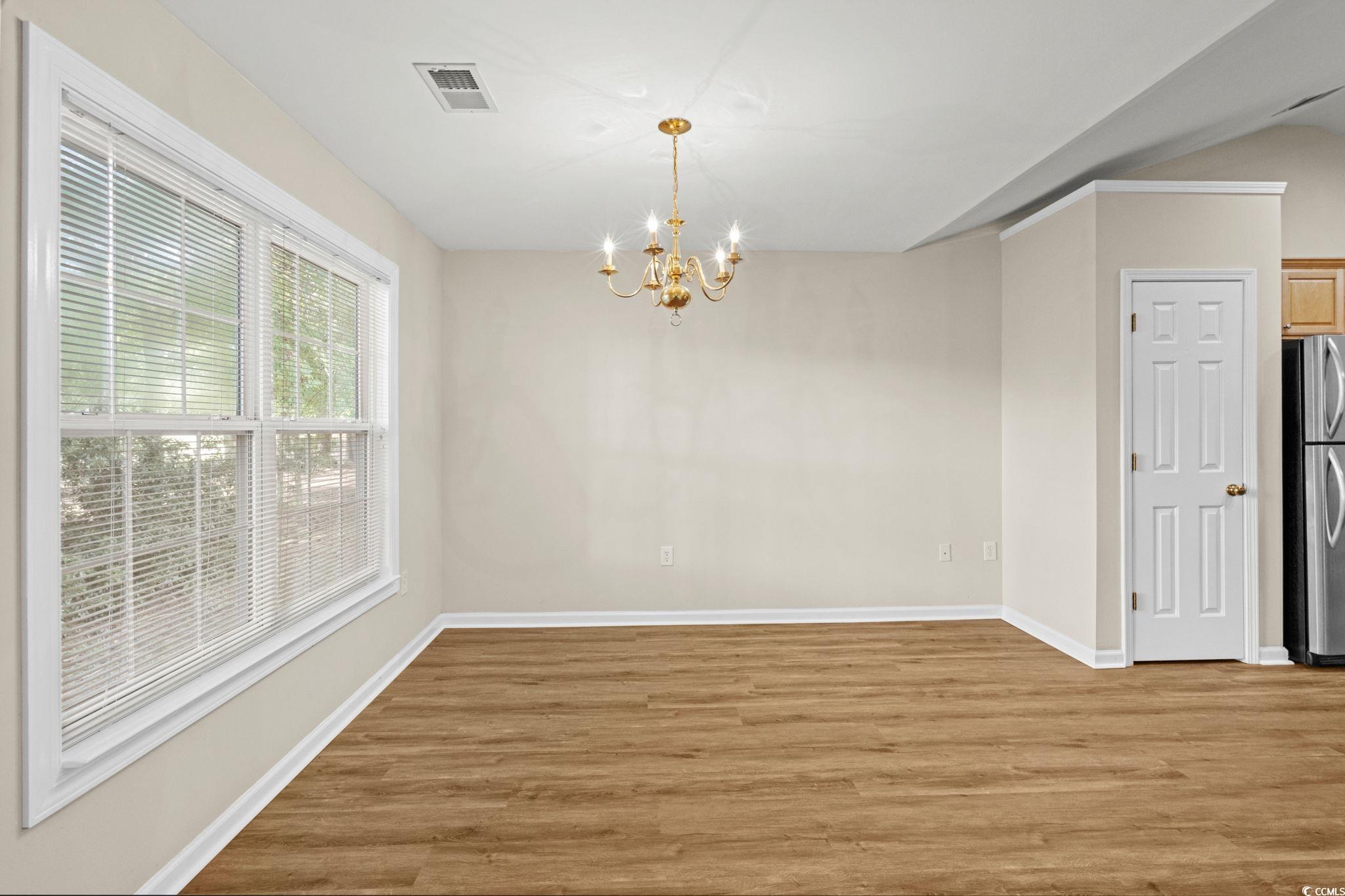 280 Barclay Drive Myrtle Beach, SC 29579 - Photo 11 of 38 Unfurnished dining area featuring light wood-type flooring and a chandelier
