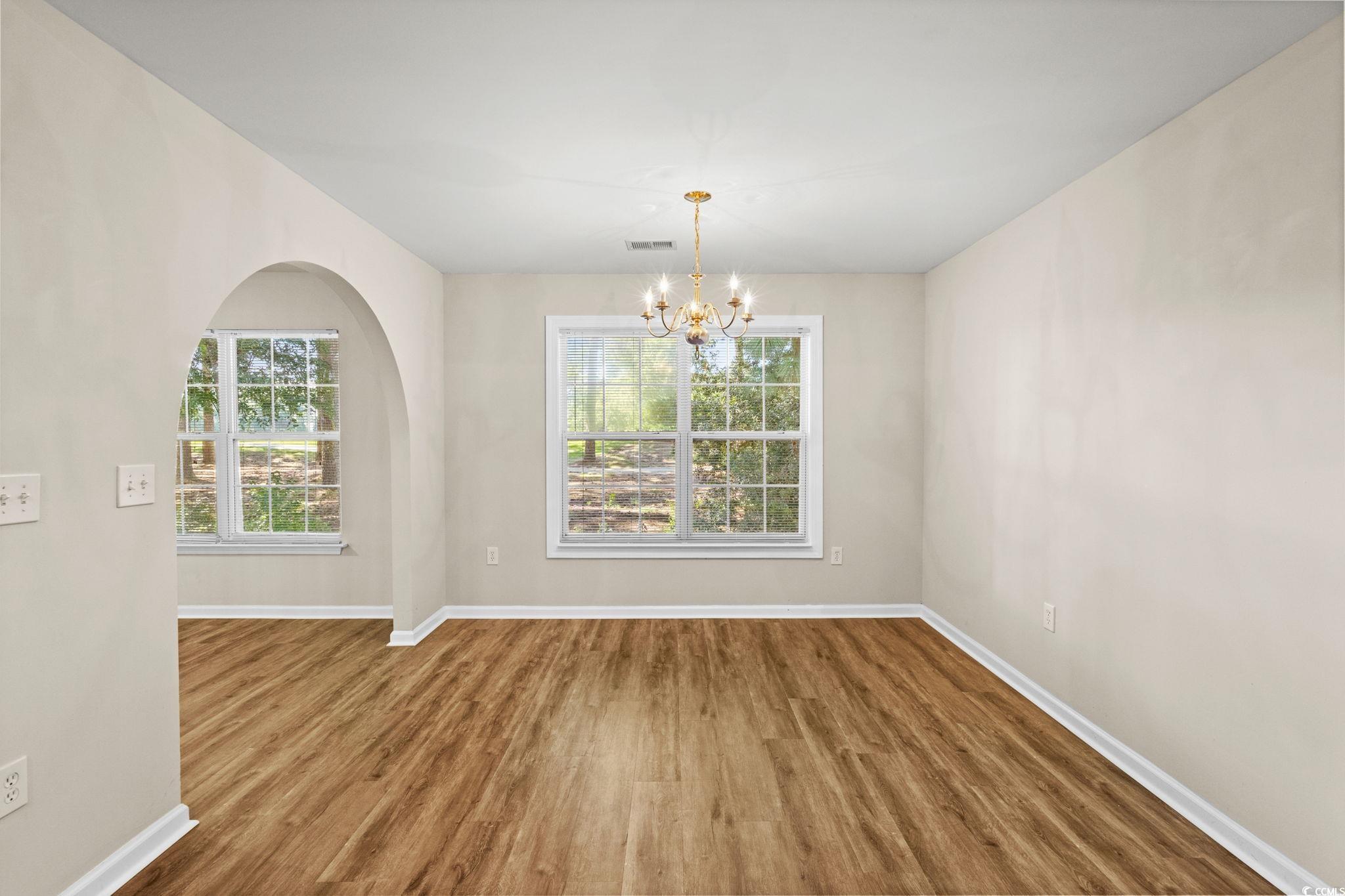 280 Barclay Drive Myrtle Beach, SC 29579 - Photo 12 of 38 Unfurnished dining area with wood finished floors and a chandelier