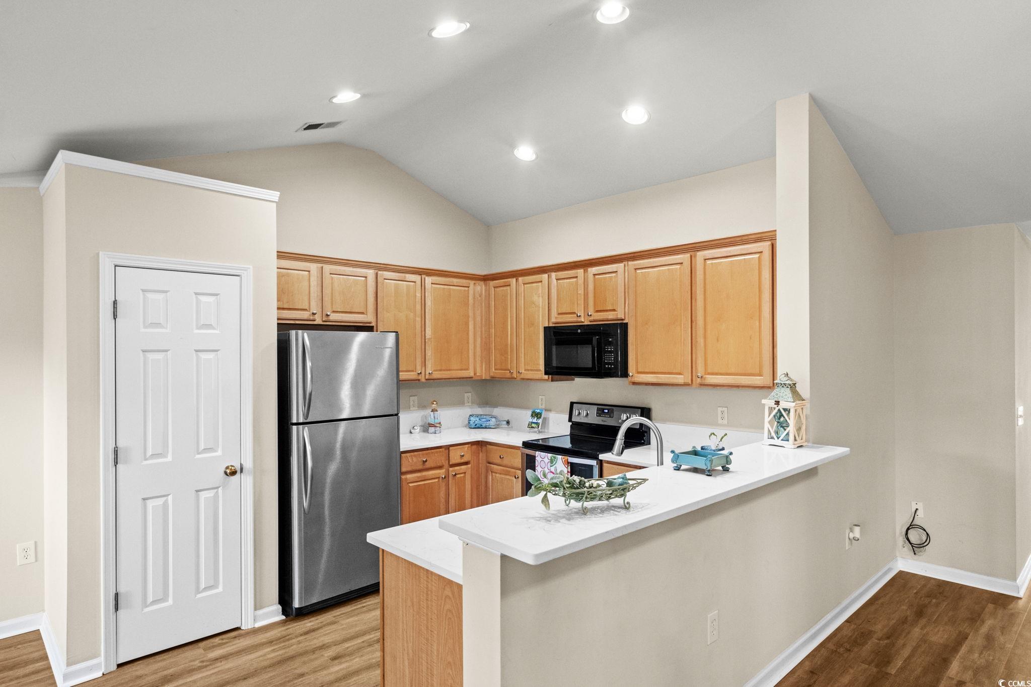 280 Barclay Drive Myrtle Beach, SC 29579 - Photo 14 of 38 Kitchen featuring stainless steel appliances, light wood-style flooring, a peninsula, vaulted ceiling, and recessed lighting