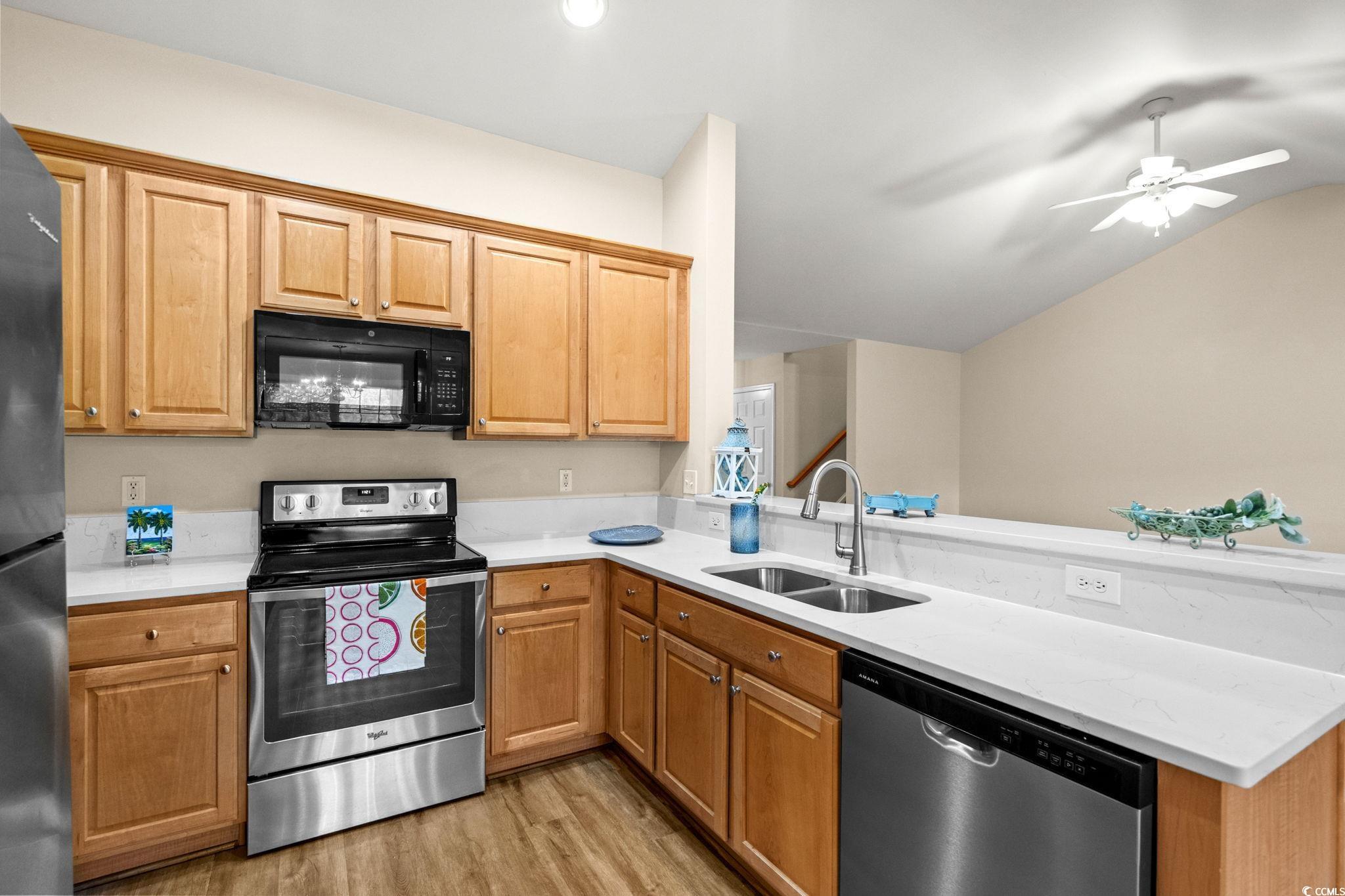 280 Barclay Drive Myrtle Beach, SC 29579 - Photo 15 of 38 Kitchen with appliances with stainless steel finishes, light wood-type flooring, a peninsula, lofted ceiling, and a ceiling fan