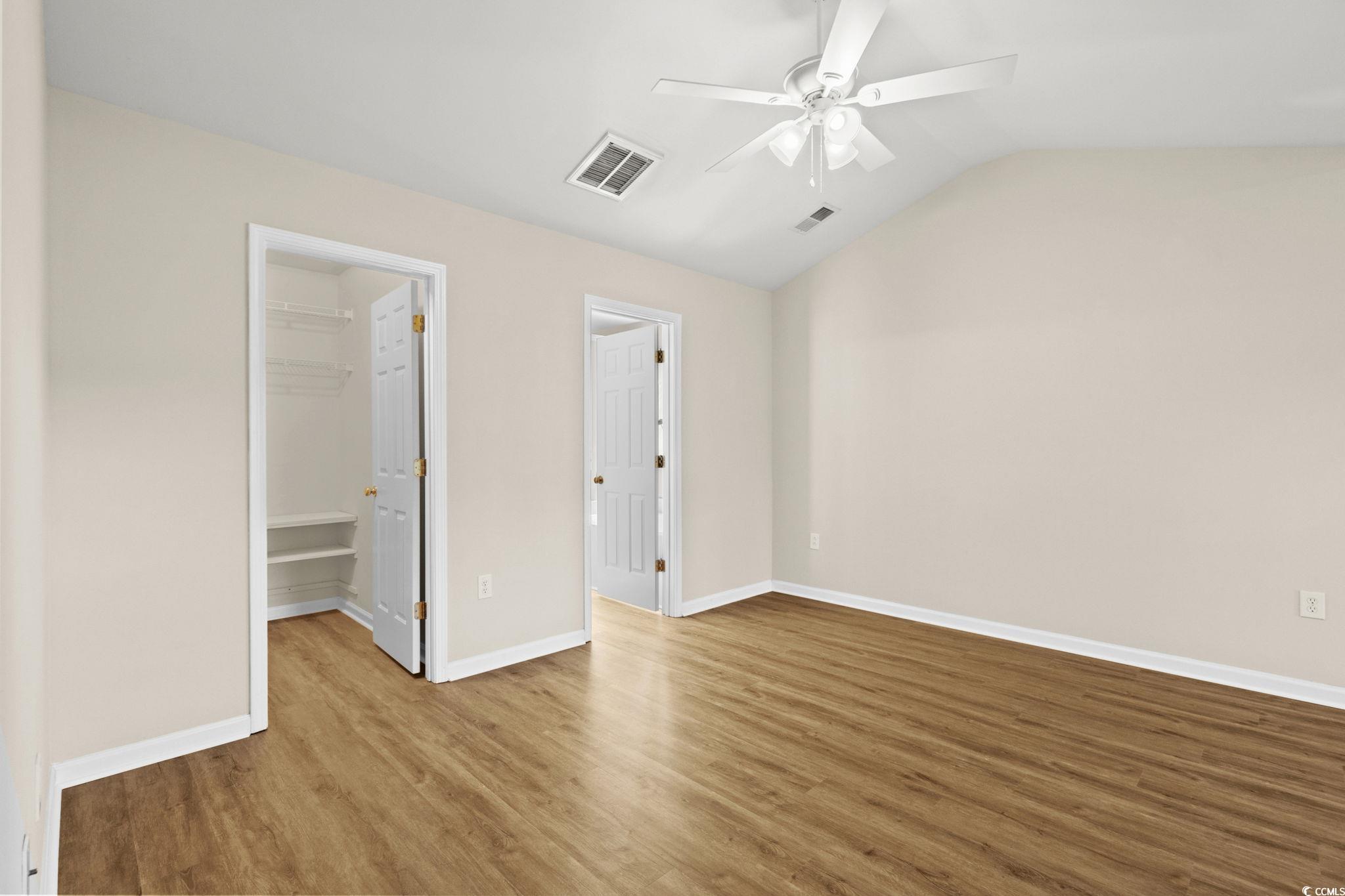 280 Barclay Drive Myrtle Beach, SC 29579 - Photo 23 of 38 Huge Primary bedroom featuring light LVP floors, a spacious closet, lofted ceiling, and ceiling fan