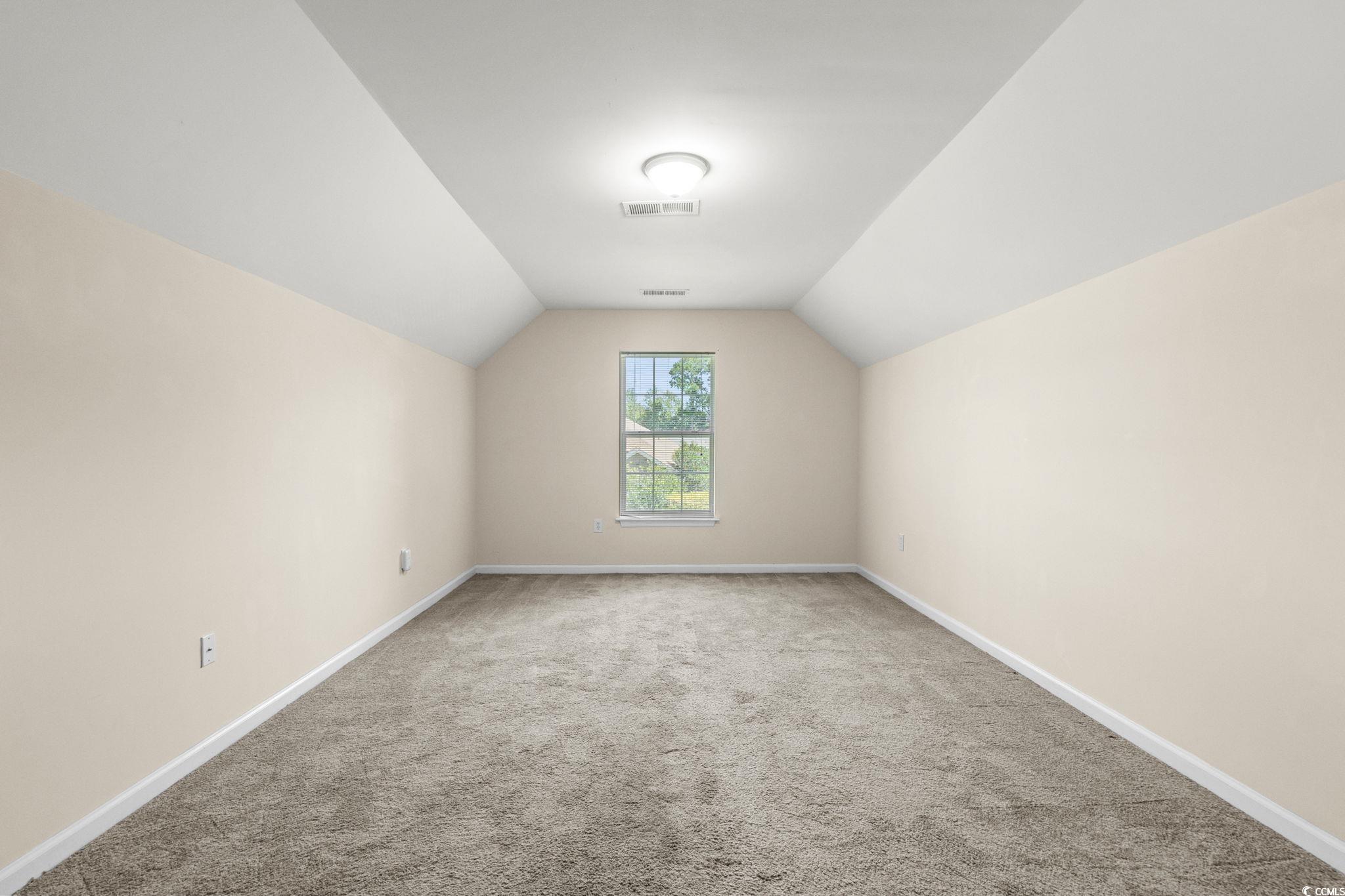 280 Barclay Drive Myrtle Beach, SC 29579 - Photo 33 of 38 Bedroom #4 over the garage with light colored carpet and lofted ceiling and a closet