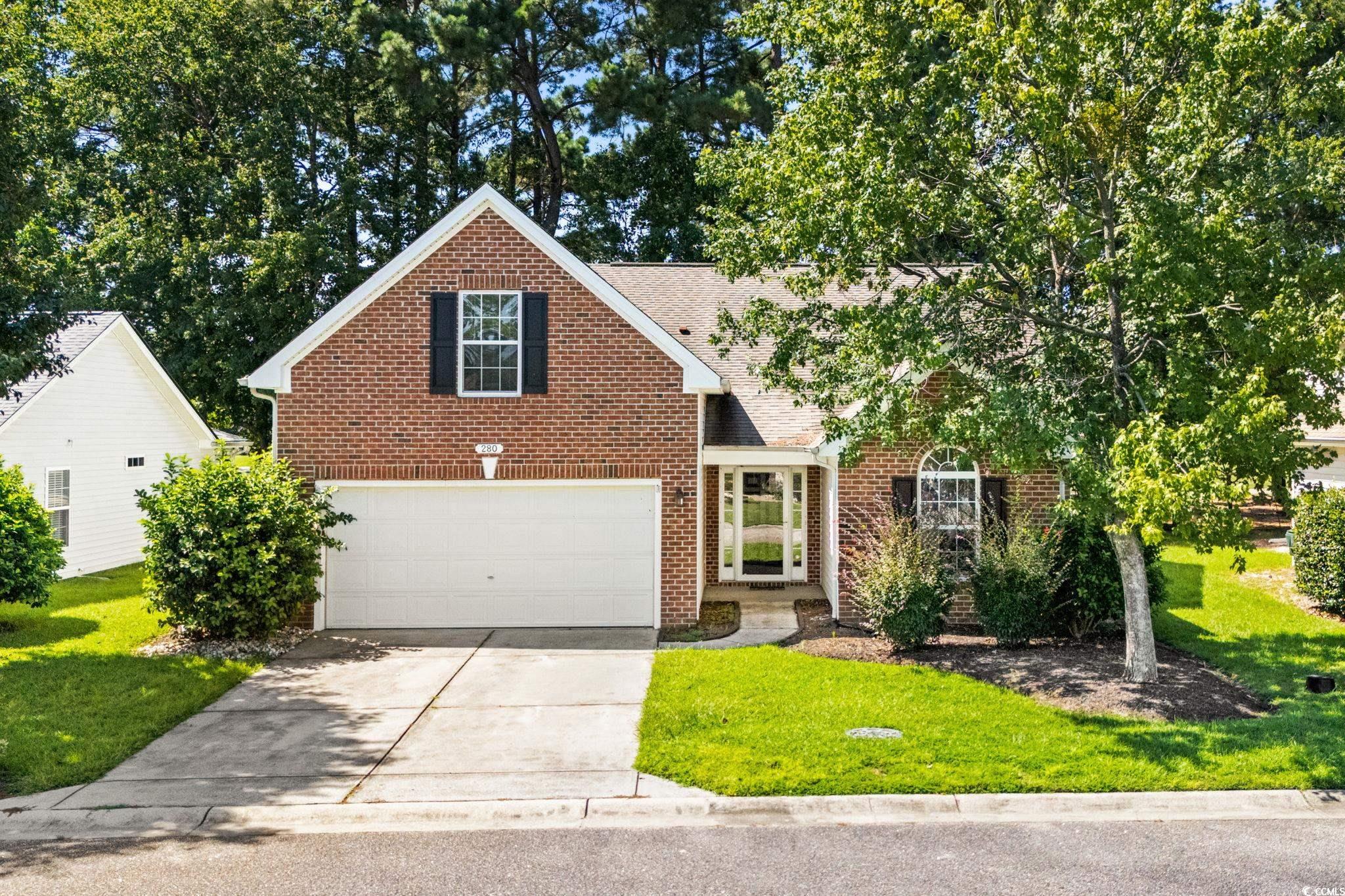 280 Barclay Drive Myrtle Beach, SC 29579 - Photo 37 of 38 Traditional-style home with driveway, a front lawn, brick siding, roof with shingles, and a garage