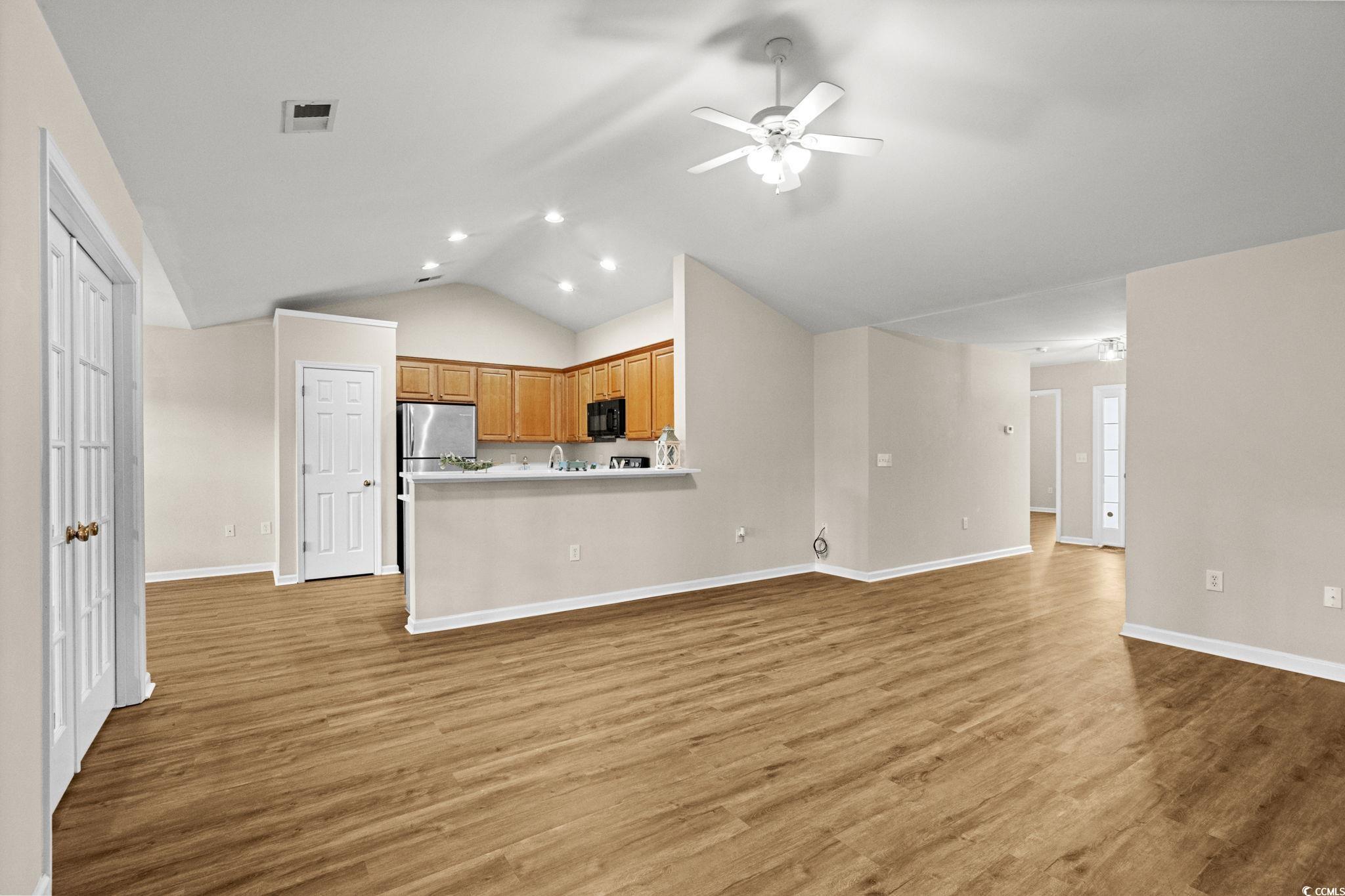 280 Barclay Drive Myrtle Beach, SC 29579 - Photo 9 of 38 Unfurnished living room with lofted ceiling, light wood-style floors, ceiling fan, and recessed lighting