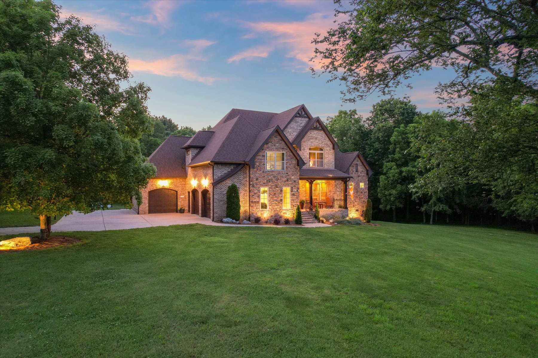 8311 Saundersville Road Mount Juliet, TN 37122 - Photo 2 of 70 a view of a big house with a big yard and large trees