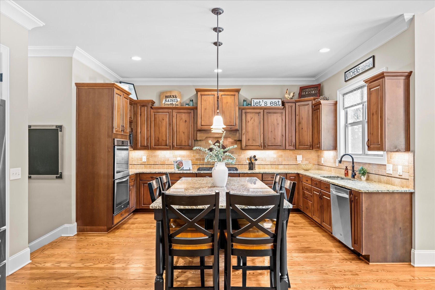 8311 Saundersville Road Mount Juliet, TN 37122 - Photo 25 of 70 a kitchen with a dining table chairs sink and granite counter tops