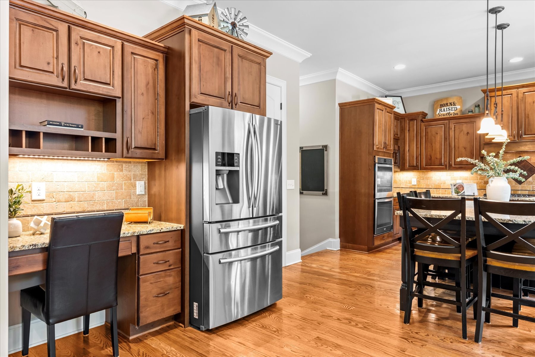 8311 Saundersville Road Mount Juliet, TN 37122 - Photo 26 of 70 a kitchen with granite countertop a refrigerator a stove a sink and chairs