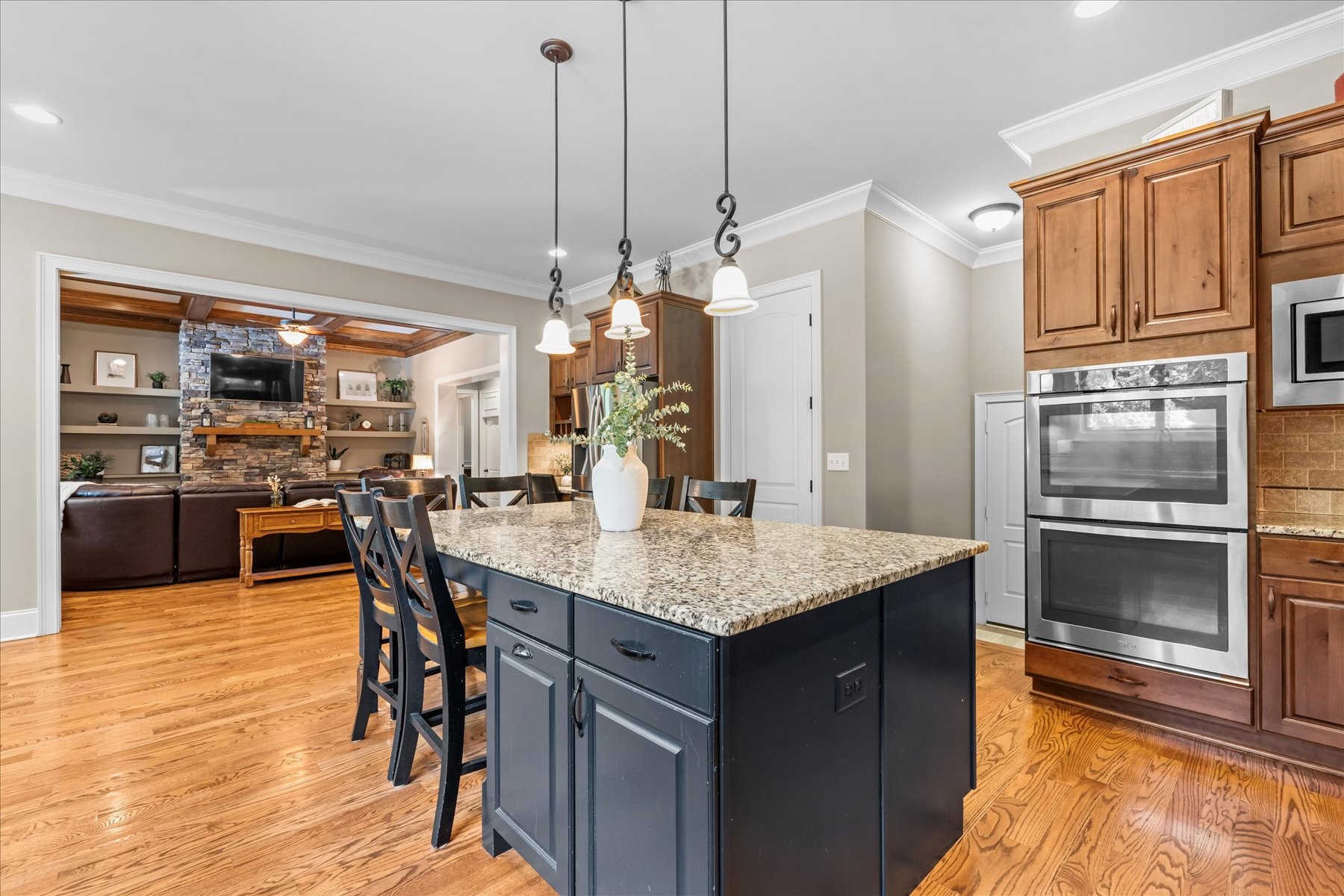 8311 Saundersville Road Mount Juliet, TN 37122 - Photo 30 of 70 a kitchen with stainless steel appliances kitchen island granite countertop a refrigerator a oven a sink with a dining table and chairs