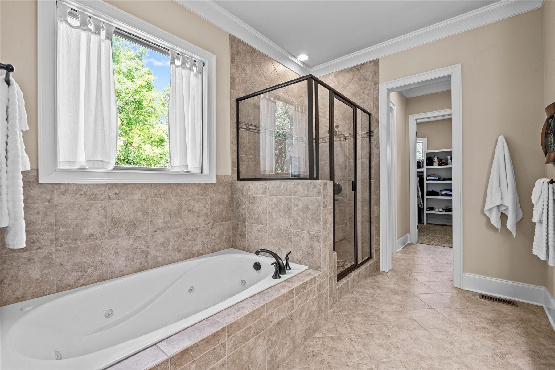 8311 Saundersville Road Mount Juliet, TN 37122 - Photo 45 of 70 a bathroom with a bathtub a shower and a window