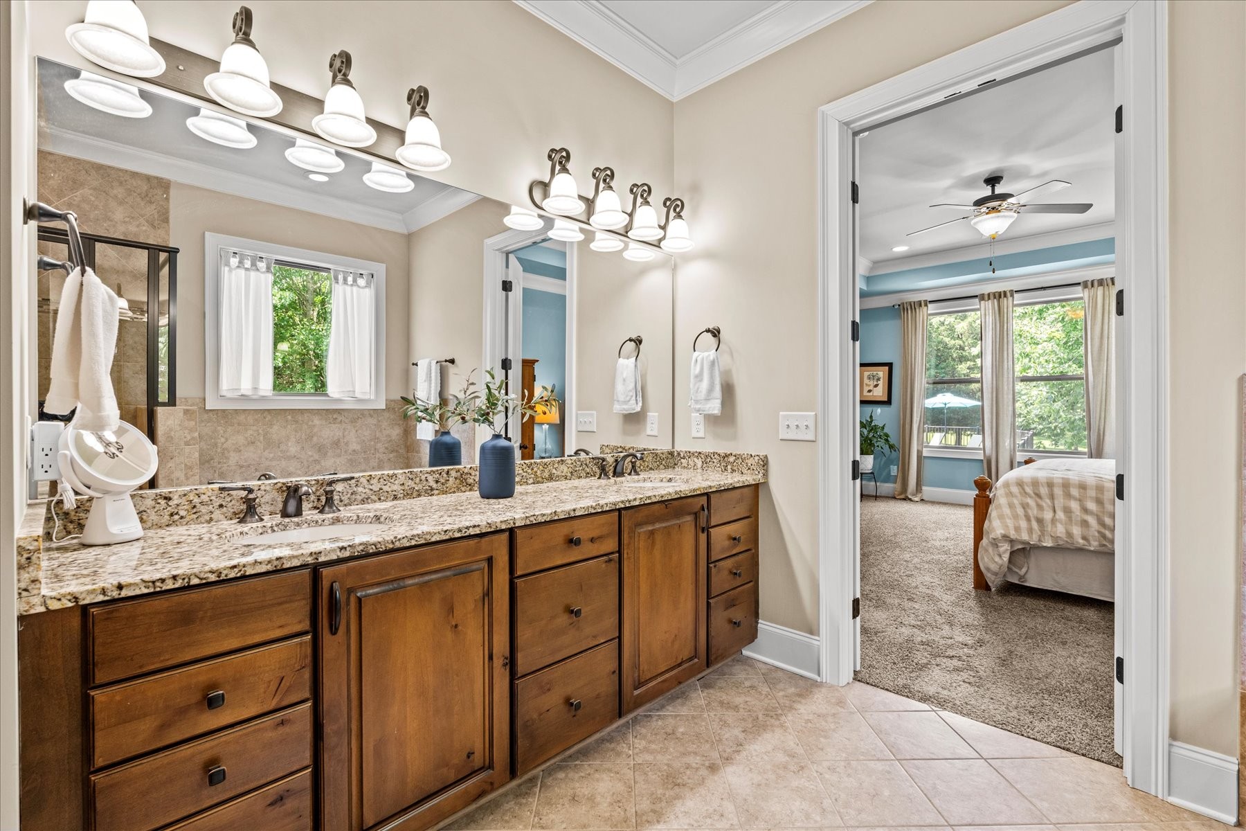8311 Saundersville Road Mount Juliet, TN 37122 - Photo 47 of 70 a spacious en suite bathroom with a granite countertop sink a large mirror and a bathtub with shower