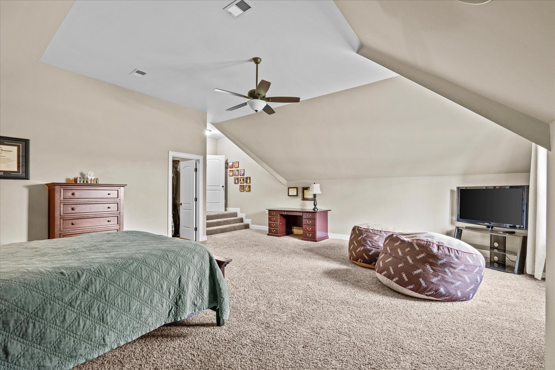 8311 Saundersville Road Mount Juliet, TN 37122 - Photo 61 of 70 a spacious bedroom with a bed a ceiling fan and a flat tv screen on a dresser