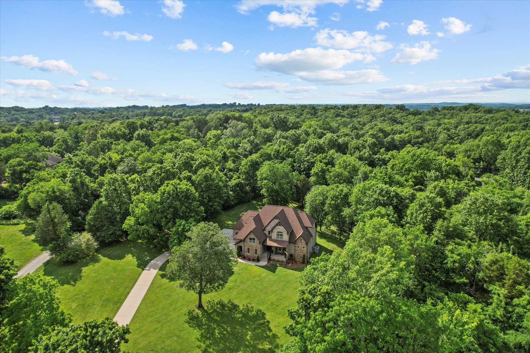 8311 Saundersville Road Mount Juliet, TN 37122 - Photo 63 of 70 a view of a garden with a building in the background