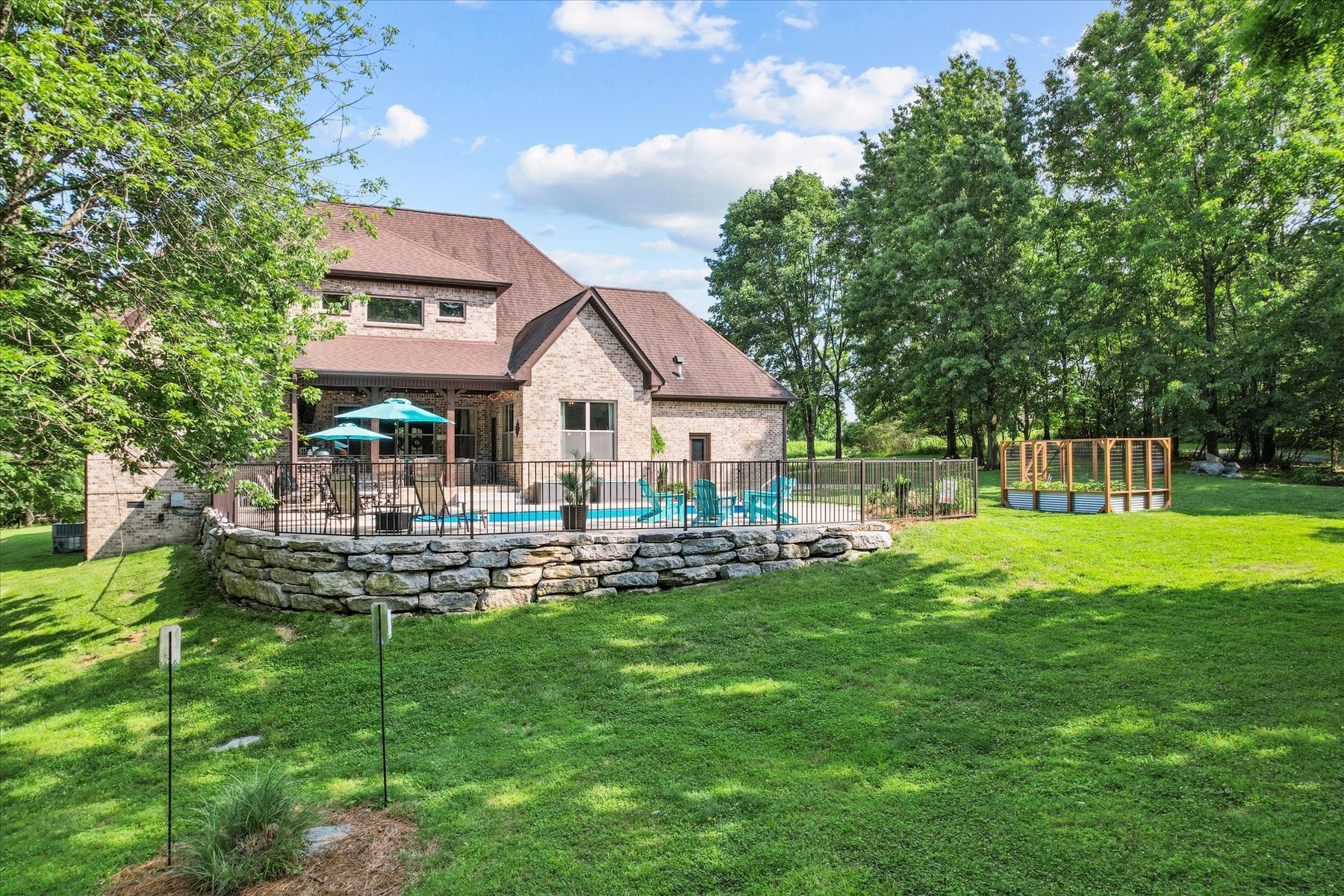 8311 Saundersville Road Mount Juliet, TN 37122 - Photo 10 of 70 a front view of a house with a garden and sitting area
