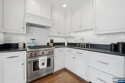 a kitchen with white cabinets and white appliances
