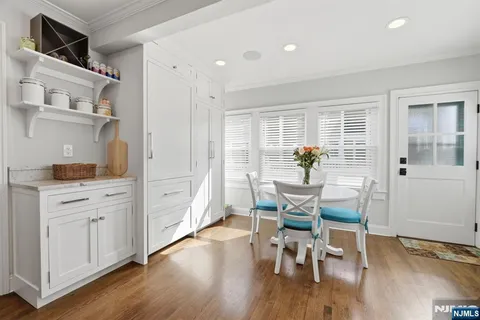 a dining room with wooden floor and breakfast area