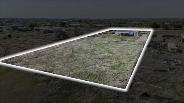 a view of a big house with a big yard and large trees