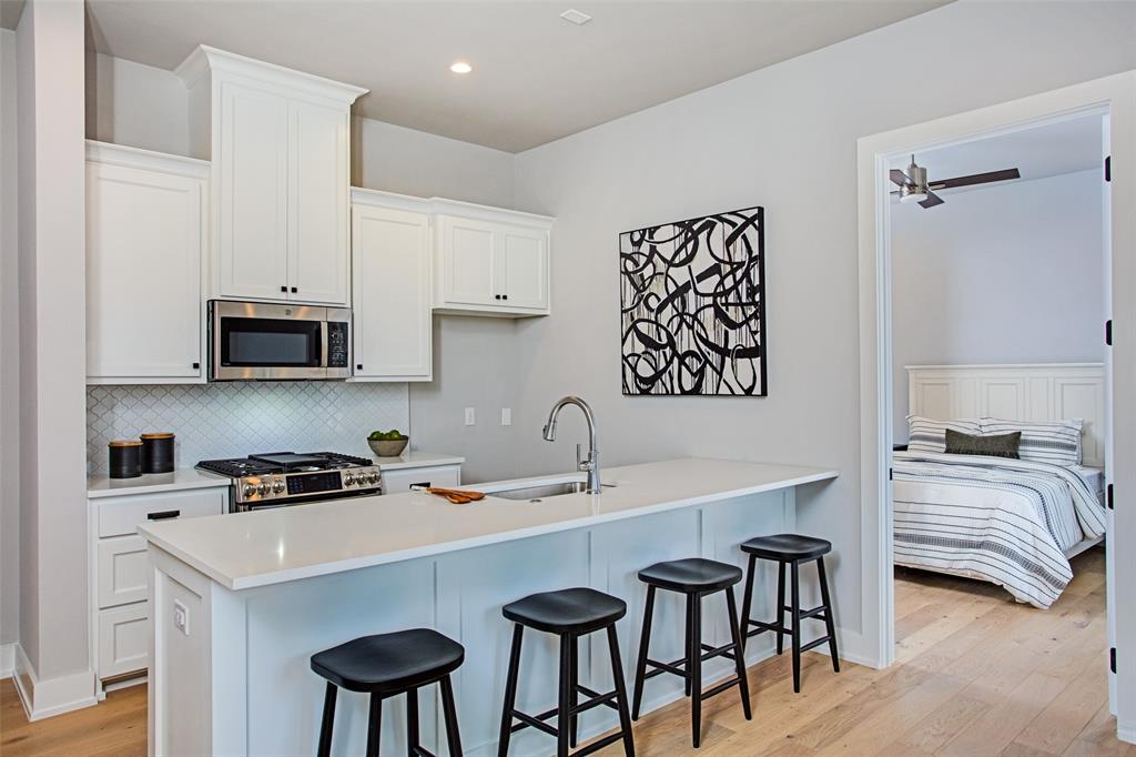 2108 Sicily Lane Haslet, TX 76052 - Photo 6 of 17 a white kitchen with a sink a stove and a refrigerator
