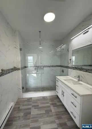 a bathroom with a double vanity sink and mirror