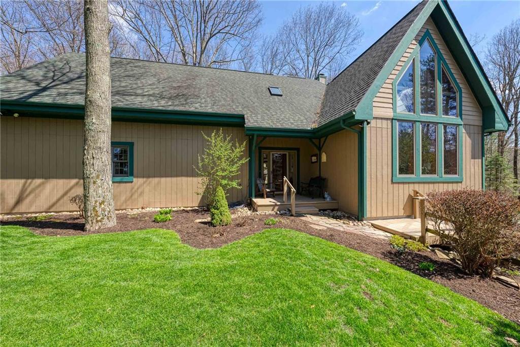 a view of a chair and table in backyard of the house