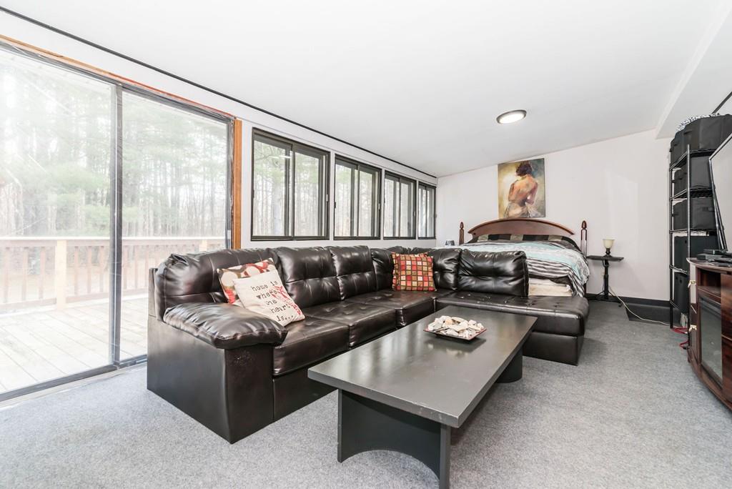 28 Damon Road Ashby, MA 01431 - Photo 11 of 34 a living room with furniture a large window and a flat tv screen