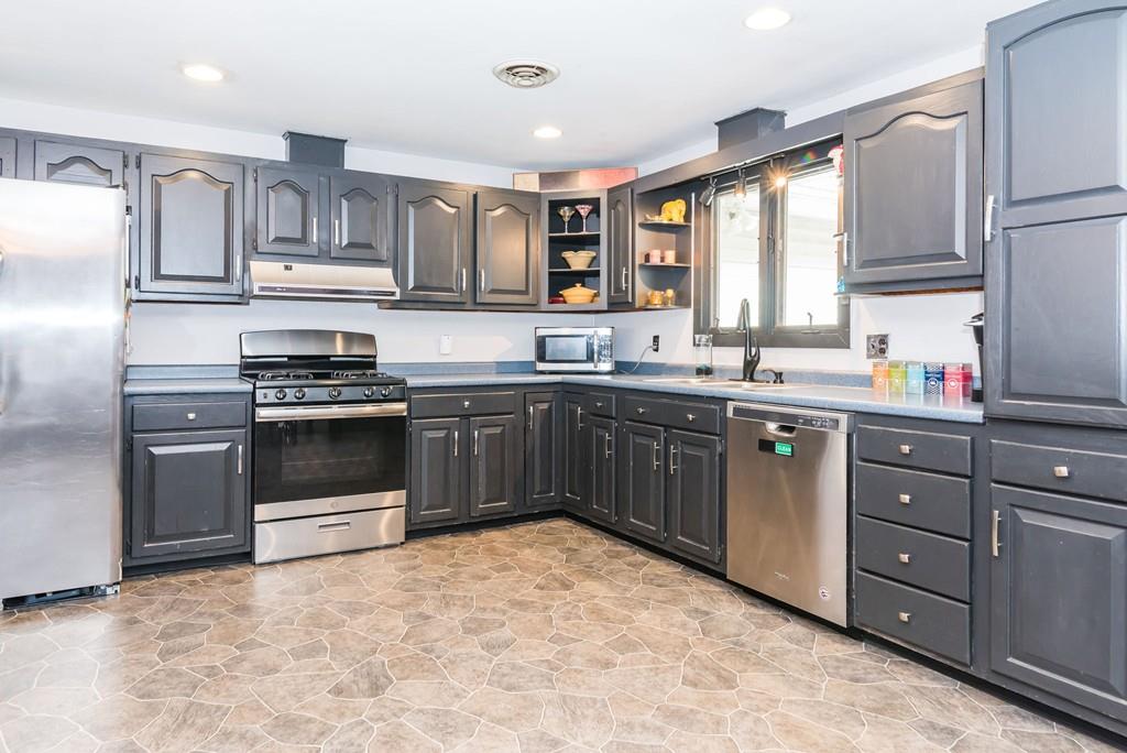 28 Damon Road Ashby, MA 01431 - Photo 3 of 34 a kitchen with stainless steel appliances granite countertop a sink a stove a refrigerator cabinets and a window