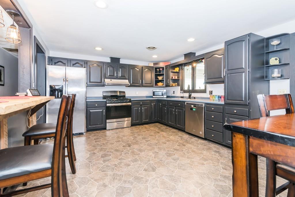 28 Damon Road Ashby, MA 01431 - Photo 4 of 34 a kitchen with a table chairs refrigerator and cabinets