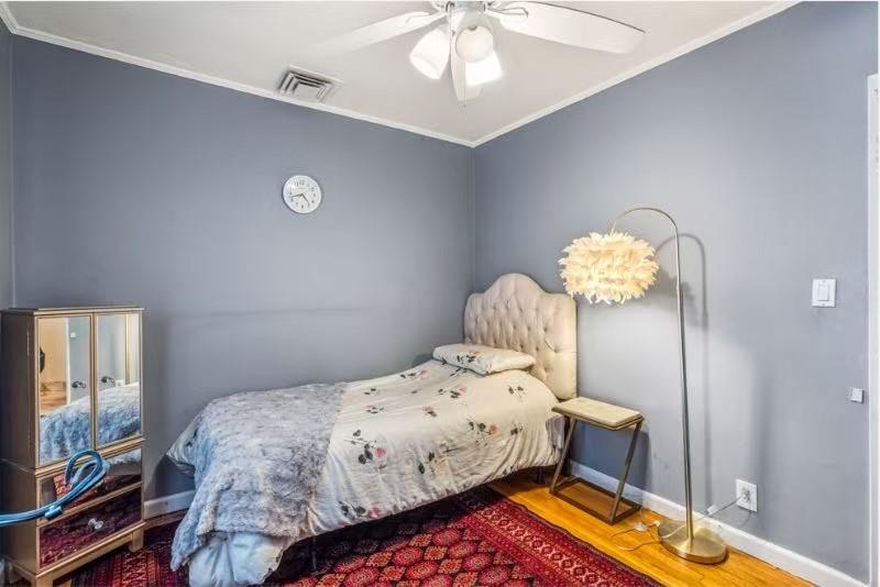 49-75 175th Place Queens, NY 11365 - Photo 13 of 21 a bedroom with a bed and chandelier